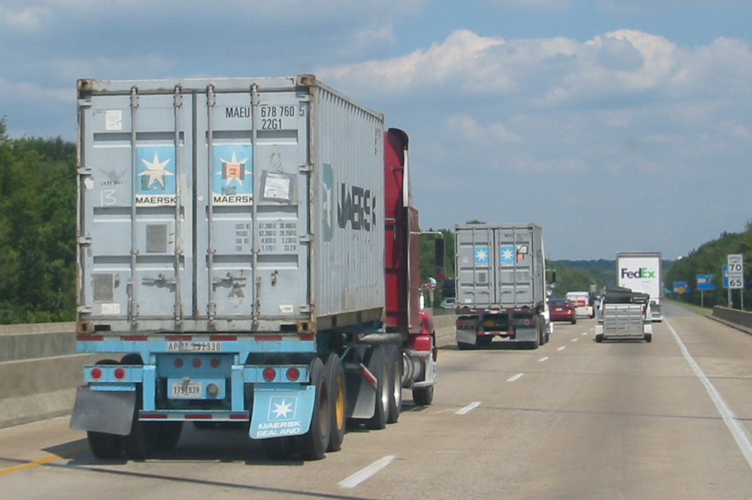 Commercial trucks traveling on an American highway